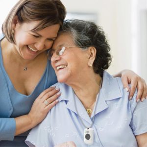 Adult woman and elderly mother embrace while smiling